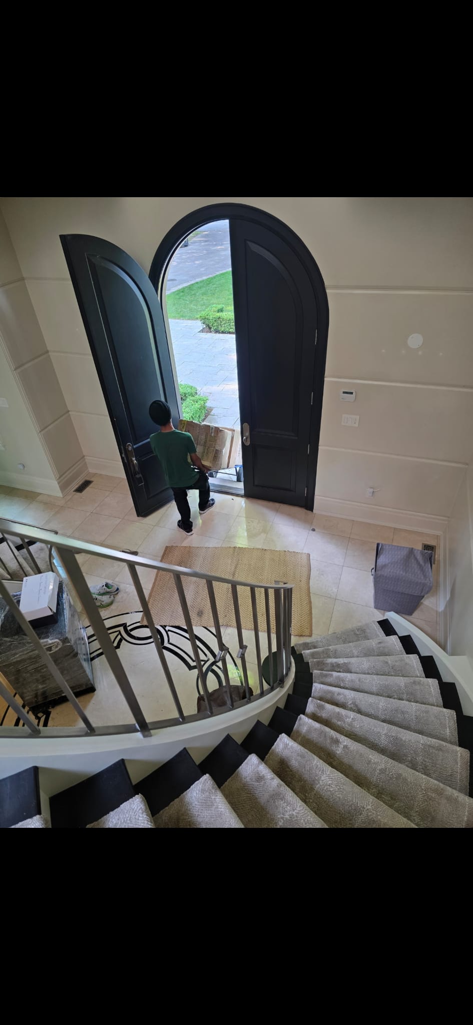 Mover carrying box through elegant entryway